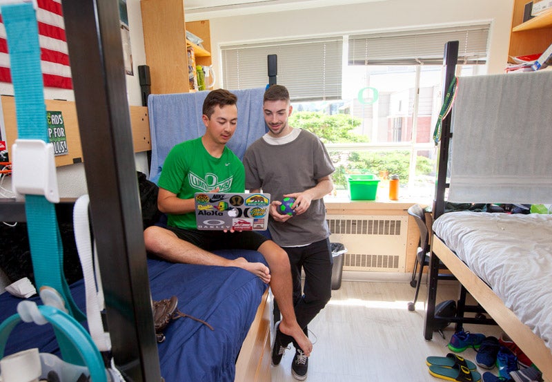 Photo of students looking at computer in Earl residence hall room.