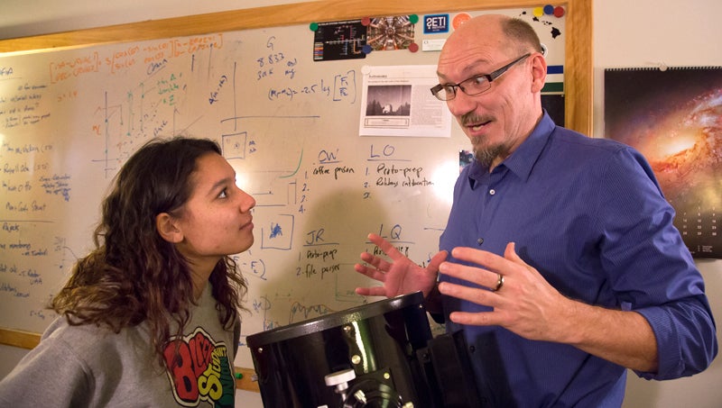 Faculty Fellow Scott Fisher talking to a student