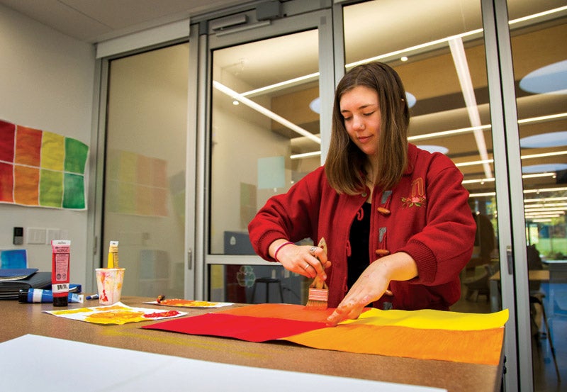 Photo of student painting on canvas