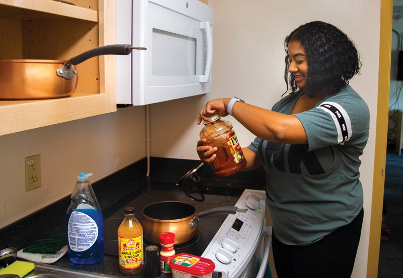 Photo of resident using kitchenette in Riley Hall