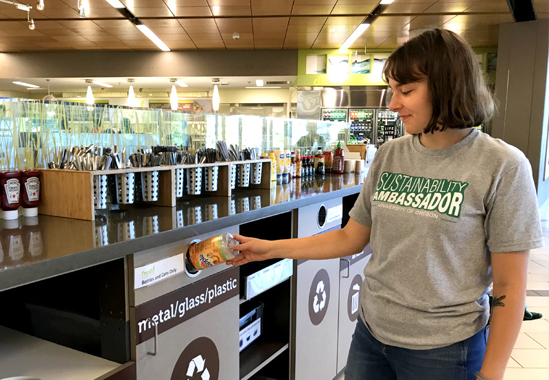UO student recycling plastic bottle in residence hall dining