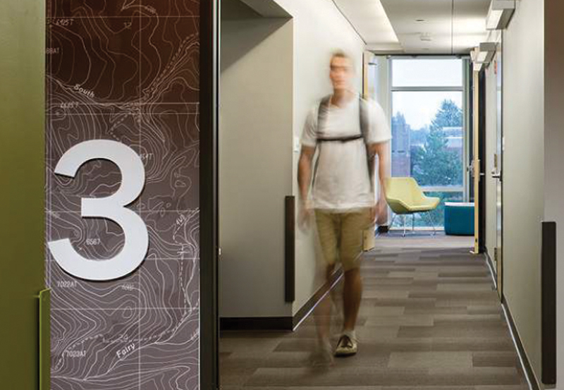 Sample rendering of student walking in hallway of future Building B